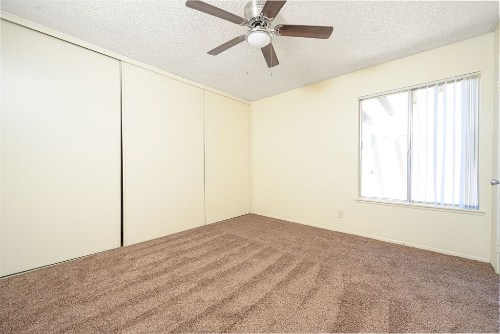 a bedroom with white walls and a ceiling fan at Villa Hemet, Hemet, 92543