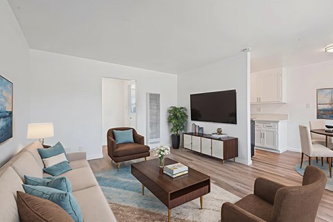A living room with a brown chair and a brown sofa.