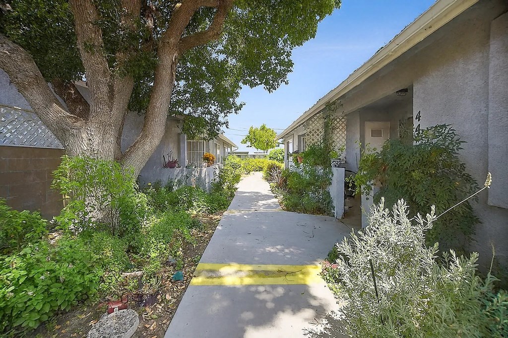A tree-lined walkway in a residential area.