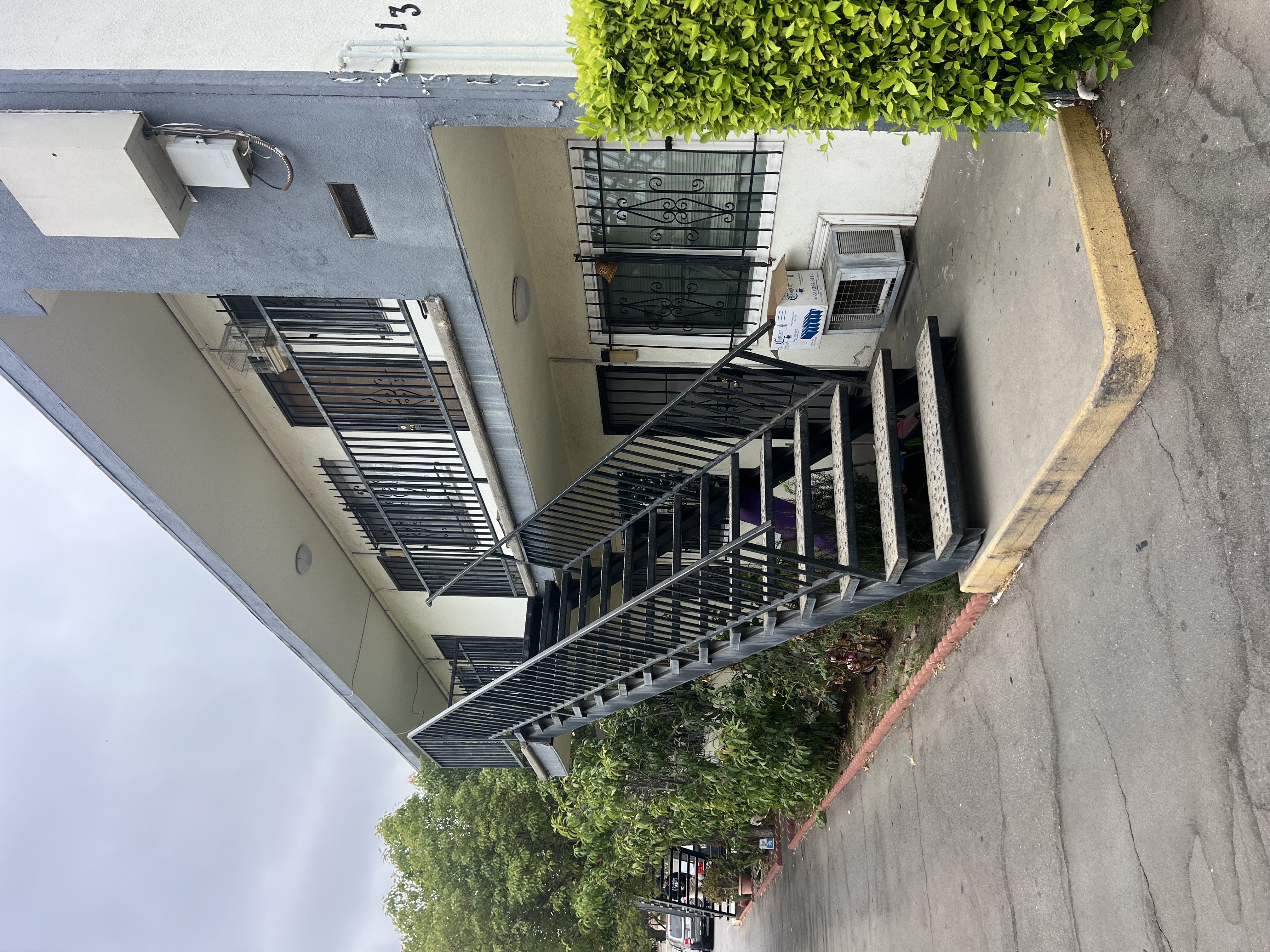 A building with a staircase and a small tree on top.