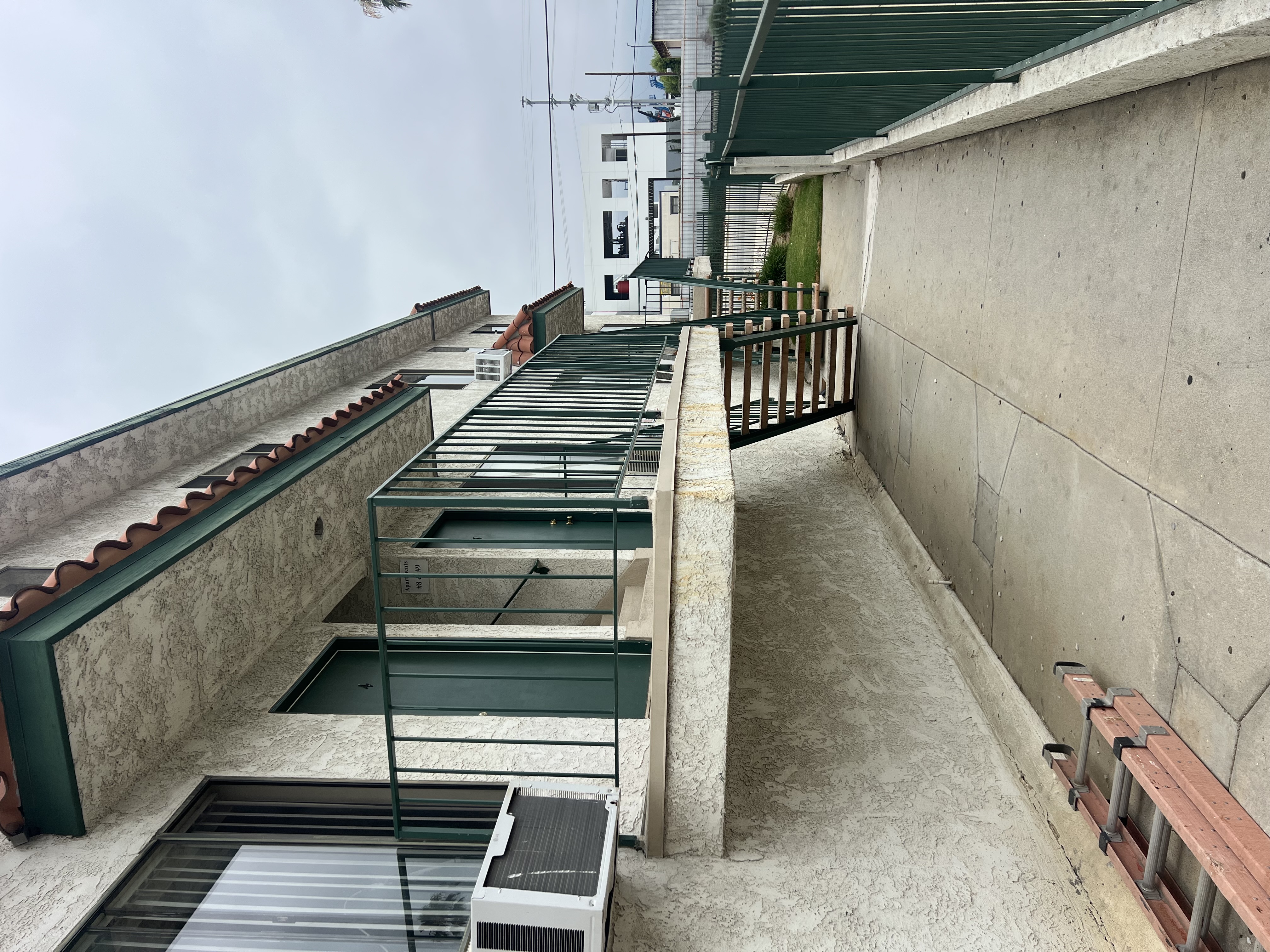 A concrete staircase with metal railings and steps leading down to a lower level.