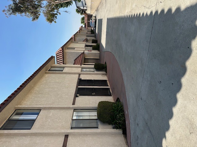 A tall building with a row of windows and balconies.
