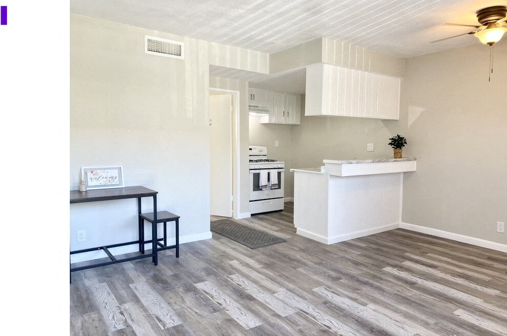 a living room with a kitchen and a table