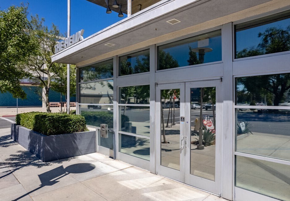 a large white building with glass doors and windows at Helix at University Village, Pomona, CA 91766