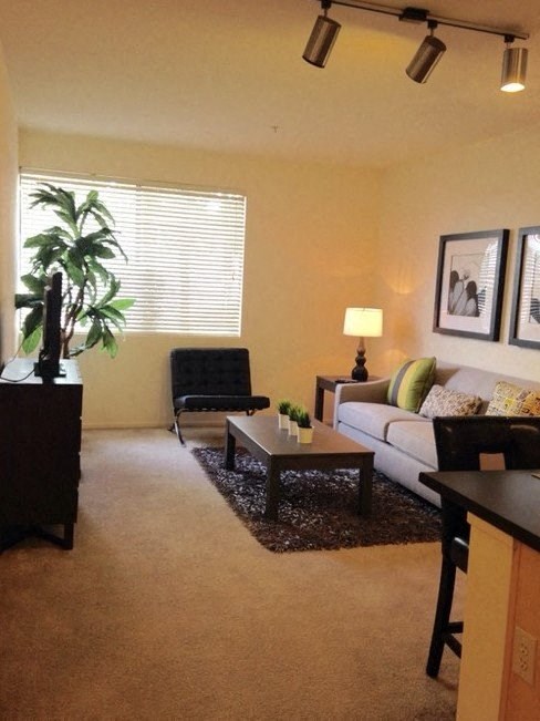 a living room with a couch and a chair at Helix at University Village, Pomona, CA