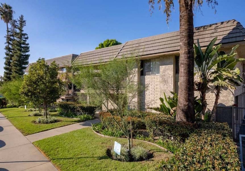 a building with a red roof and a sidewalk in front of it at Mountainview Venture, Covina, CA