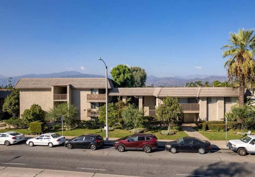an apartment complex with cars parked in front of it at Mountainview Venture, Covina, CA 91722
