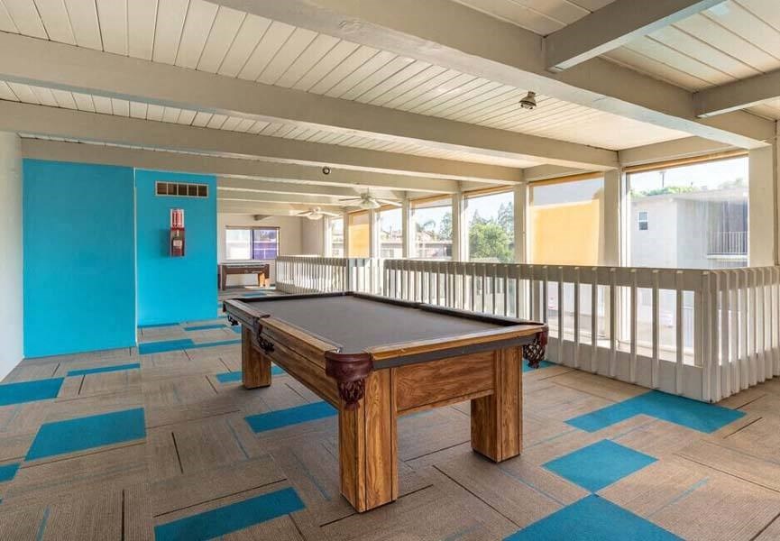 a pool table sitting on top of a wooden table at Mountainview Venture, Covina