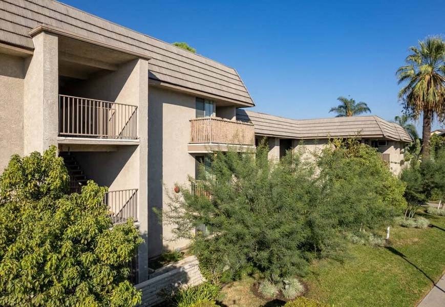 a building with two balconies and trees in front of it at Mountainview Venture, Covina, 91722