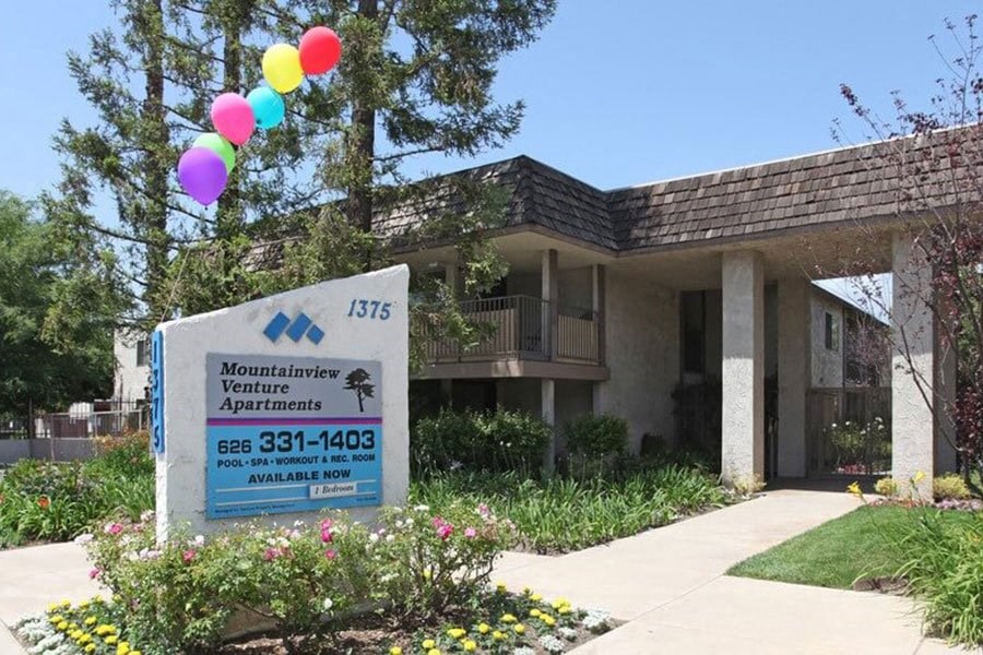 a building with a sign and balloons in front of it at Mountainview Venture, Covina, CA