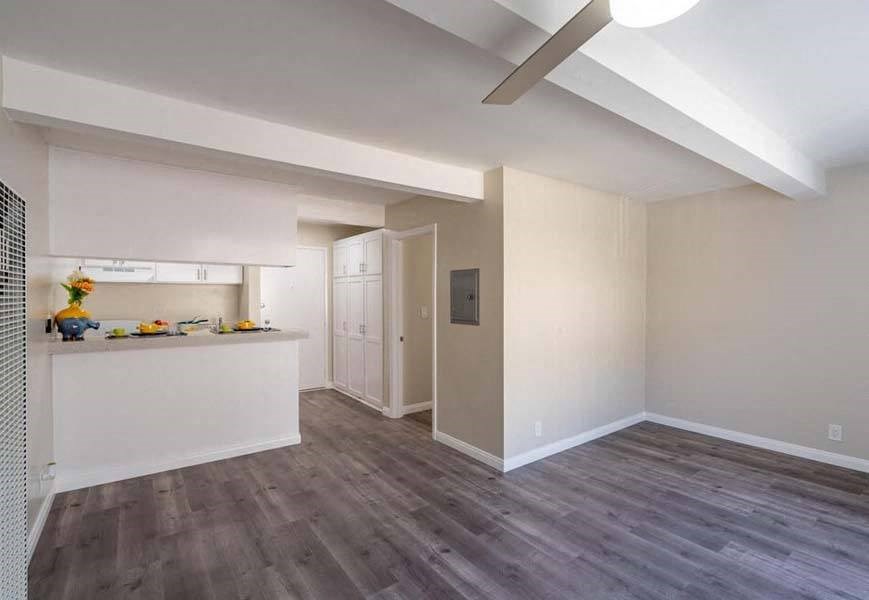 a kitchen and living room with hardwood floors and a ceiling fan at Mountainview Venture, California