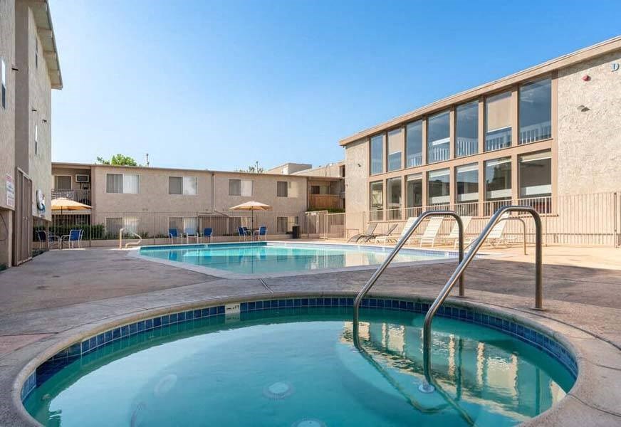 a resort style pool and hot tub with a building in the background at Mountainview Venture, California