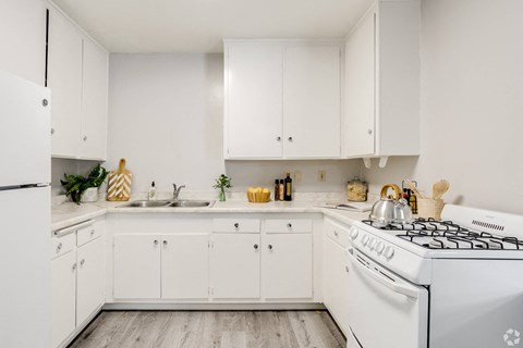 a white kitchen with white appliances and white cabinets a white kitchen with white appliances and white cabinets at University Park, Azusa, CA