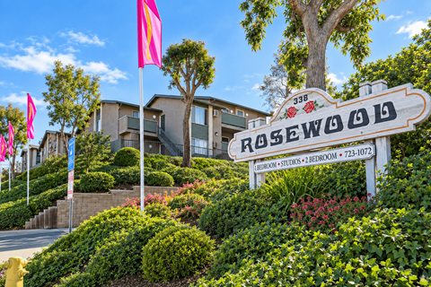 A sign for Rosewood in front of a building.