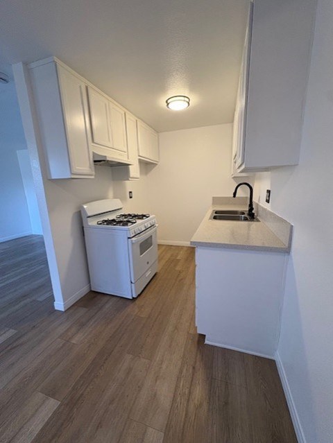 A small kitchen with a white stove and oven.