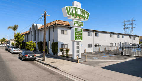 A sign for Townhouse in Brea, California is shown in front of a building.