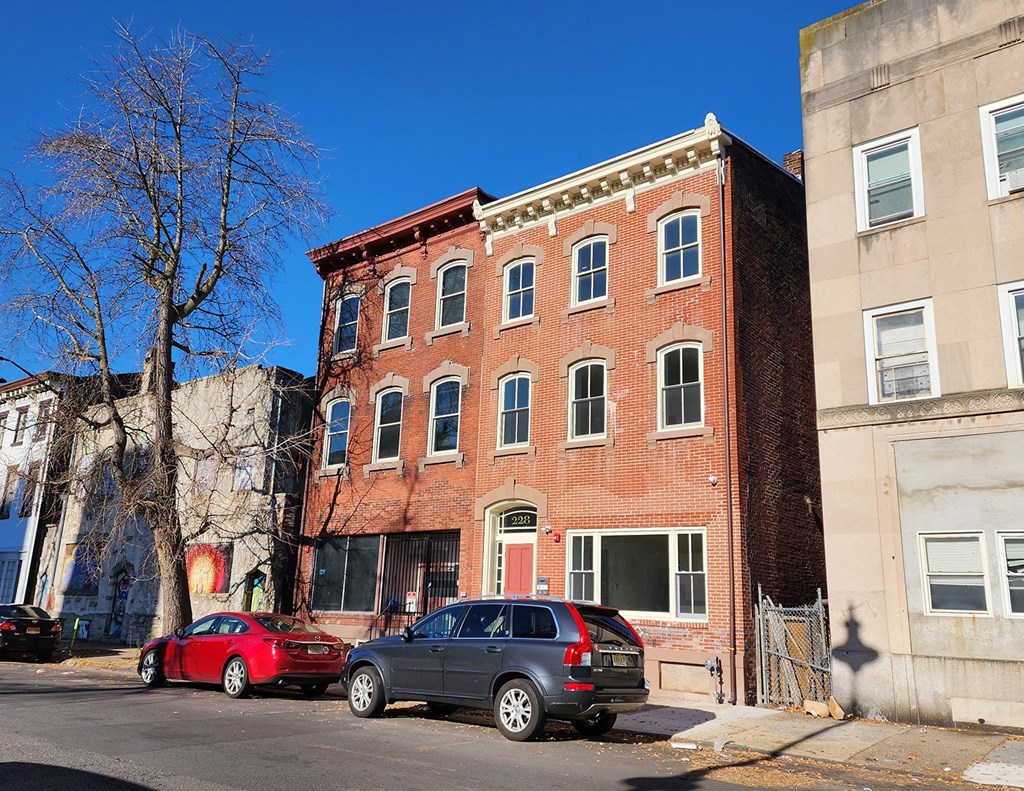 A red brick building with a green lawn in front.
