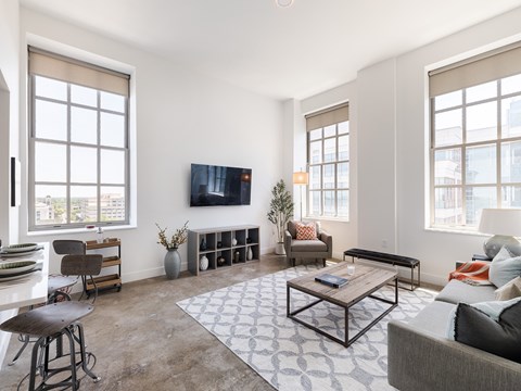 Open concept living room with contemporary furnishings at The Bell Apartments, Trenton, New Jersey