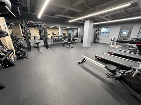 Fitness center with cardio and strength training equipment at The Bell Apartments, New Jersey, 08608