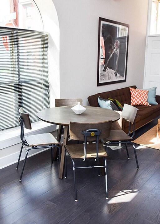 A dining table with four chairs around it.