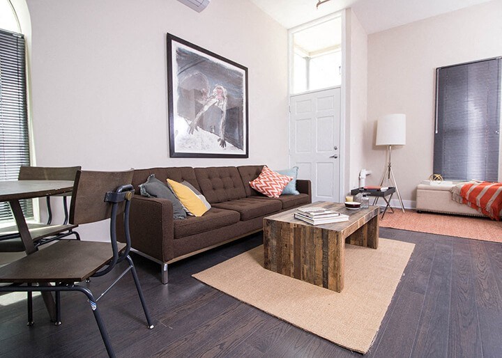 A living room with a brown couch and a coffee table.