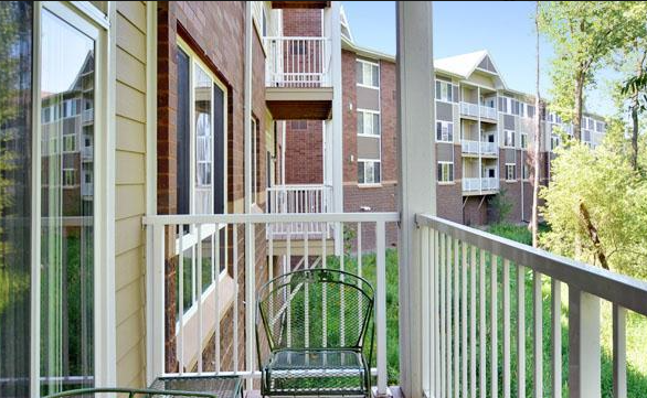 a balcony with a chair and a window