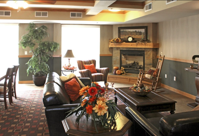 a community room filled with furniture and a fire place