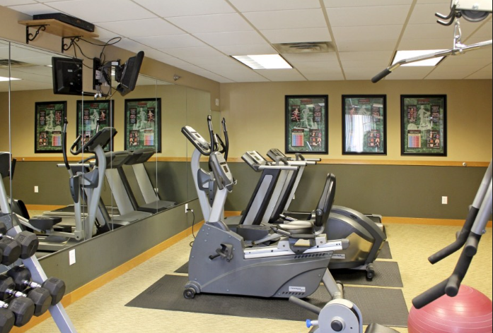 a fitness room filled with exercise equipment
