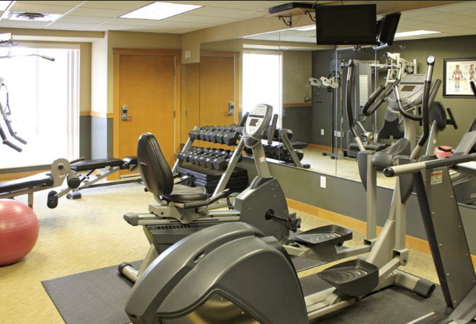 a fitness room filled with exercise equipment and weights