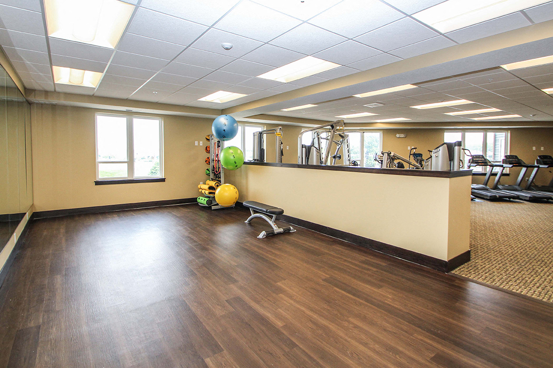 a large fitness room with wood flooring and yoga balls at The Flats at Cedar Grove, Minnesota