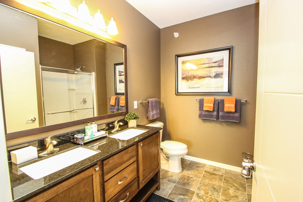 a bathroom with a large mirror and two sinks at The Flats at Cedar Grove, Minnesota, 55122