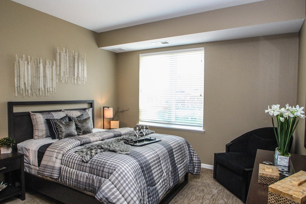 a bedroom with a bed and a window at The Flats at Cedar Grove, Eagan, MN, 55122