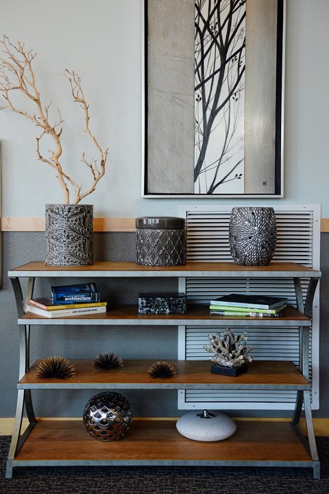 a living room with a bookshelf and a picture on the wall