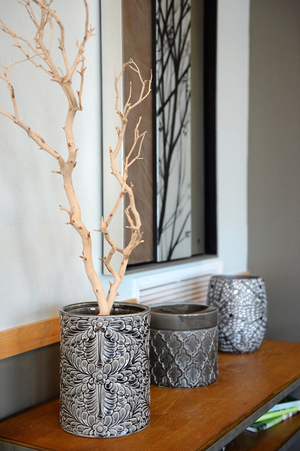 a small table with three vases on it at Hearthstone Apartments and Townhomes, Minnesota