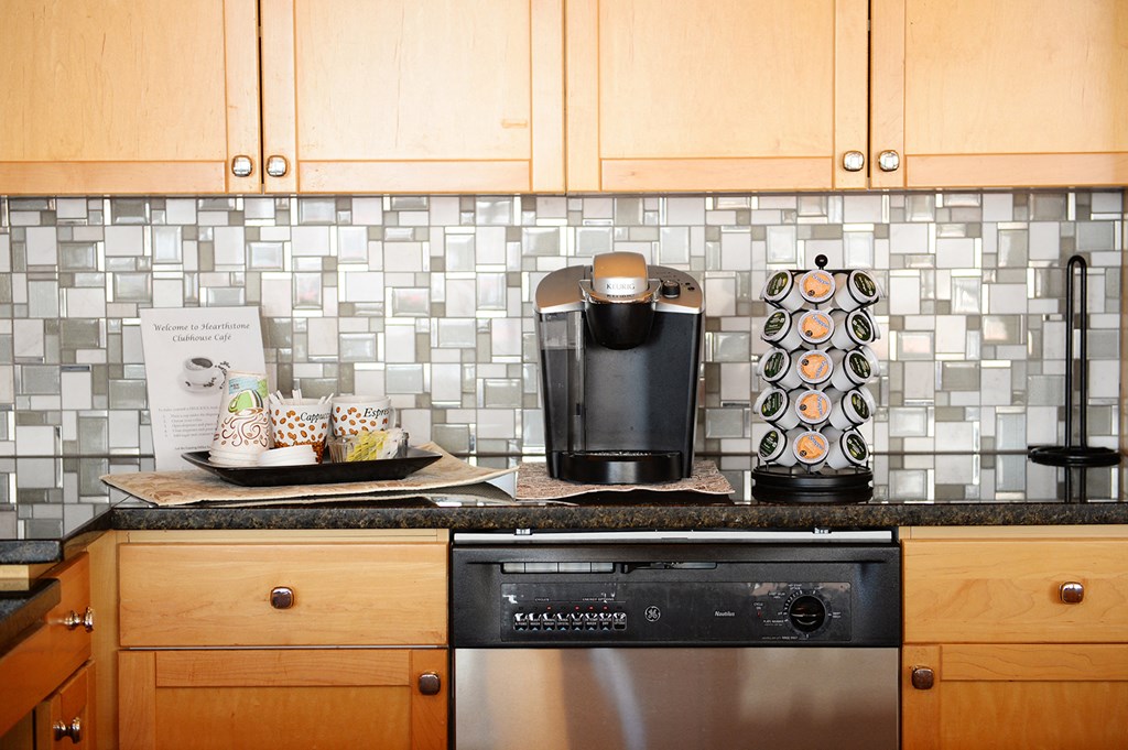 a kitchen with wood cabinets and stainless steel appliances