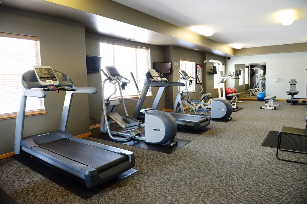 a fitness room filled with various exercise equipment at Hearthstone Apartments and Townhomes, Apple Valley