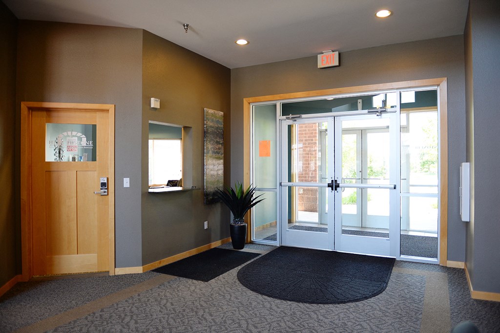 an entryway with a glass door and a plant in the corner at Hearthstone Apartments and Townhomes, Minnesota, 55124