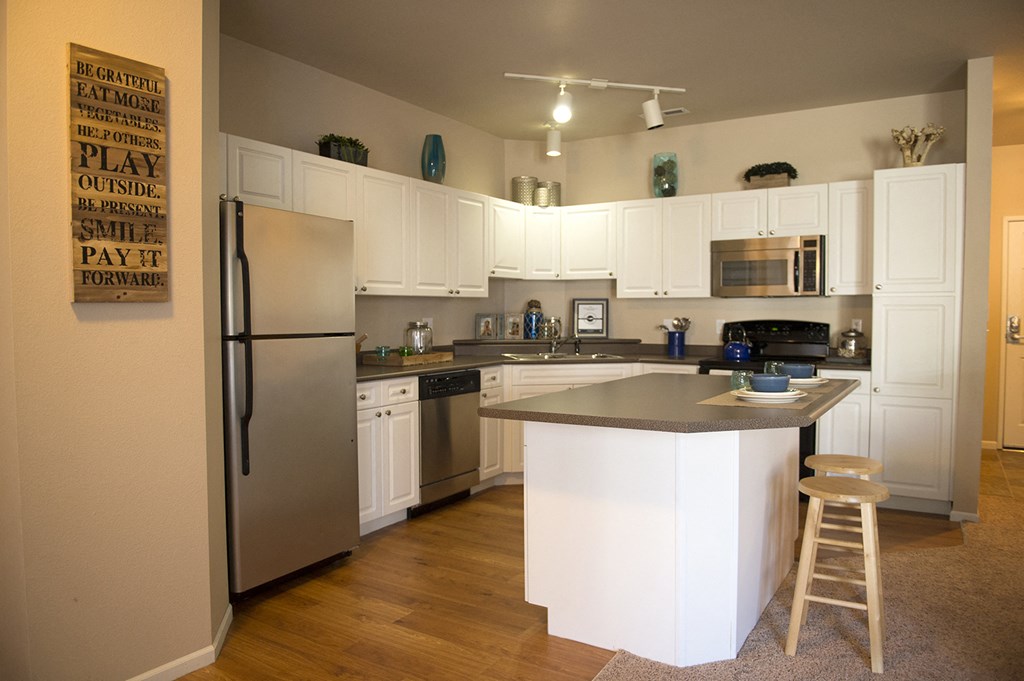 a kitchen with white cabinets and stainless steel appliances at Hearthstone Apartments and Townhomes, Apple Valley, MN, 55124