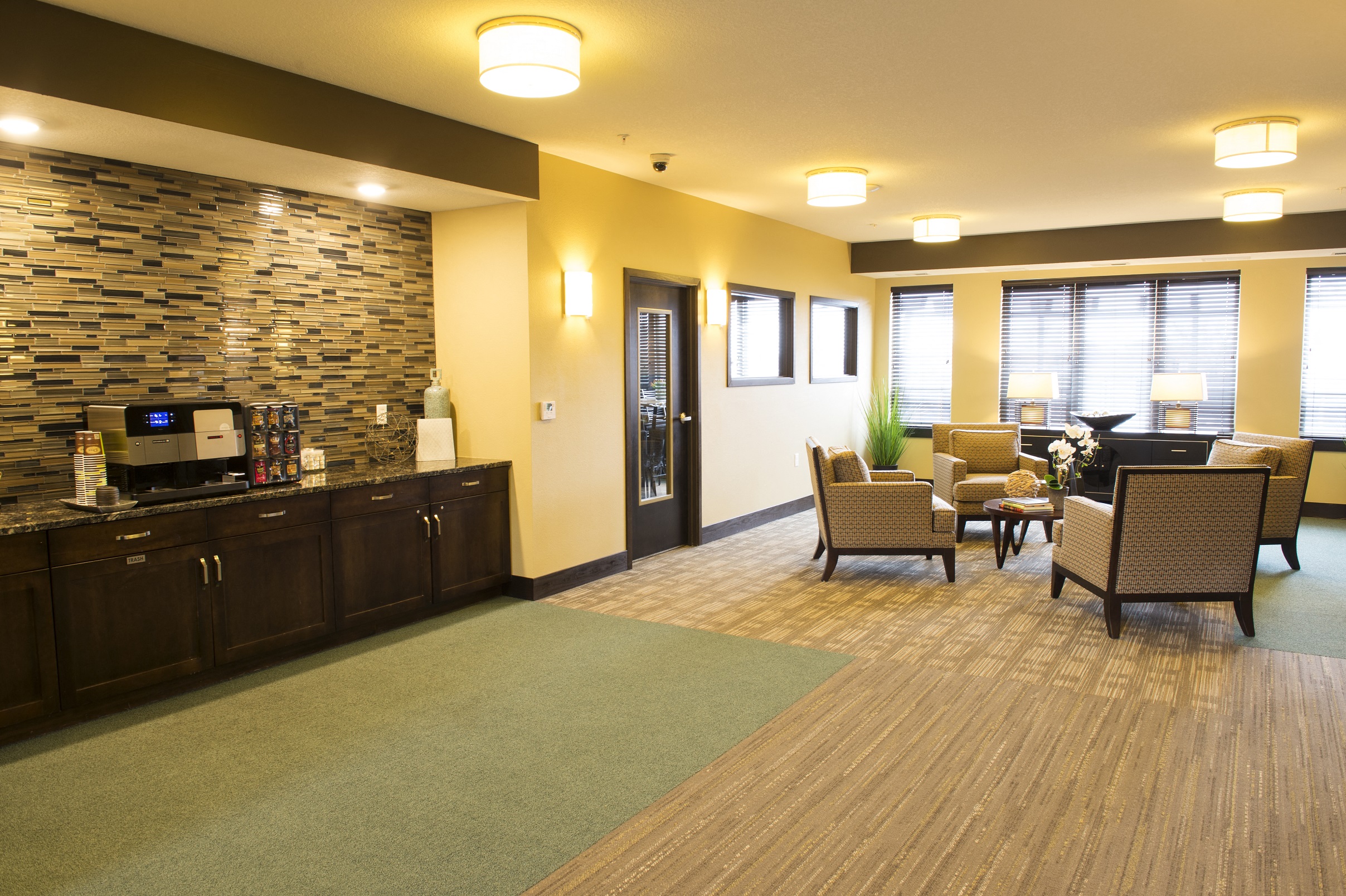 a reception area with chairs and a coffee bar at The Flats at Cedar Grove, Minnesota, 55122