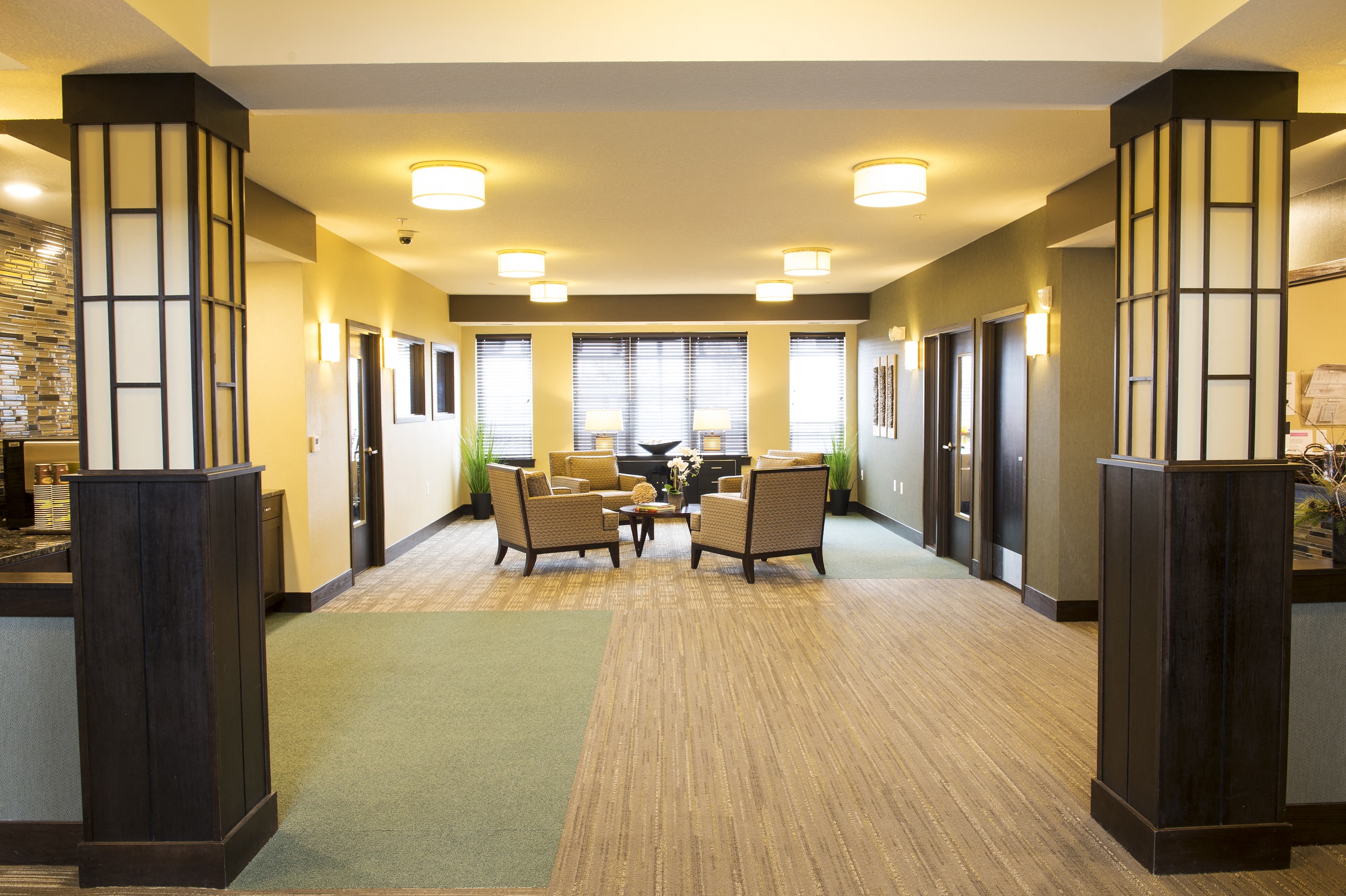 a large common area with chairs and tables at The Flats at Cedar Grove, Eagan, MN