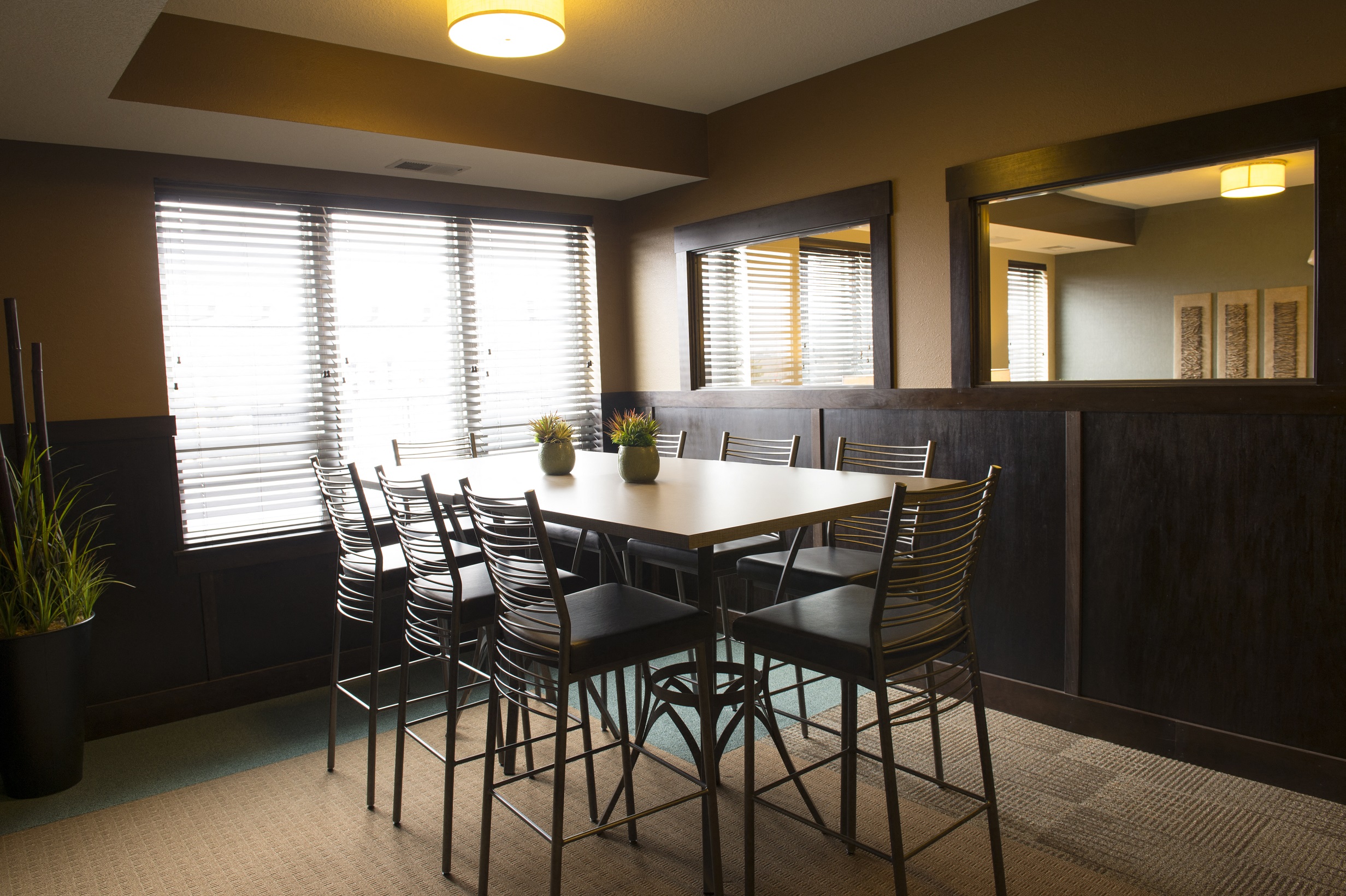 a meeting room with a table and chairs at The Flats at Cedar Grove, Minnesota