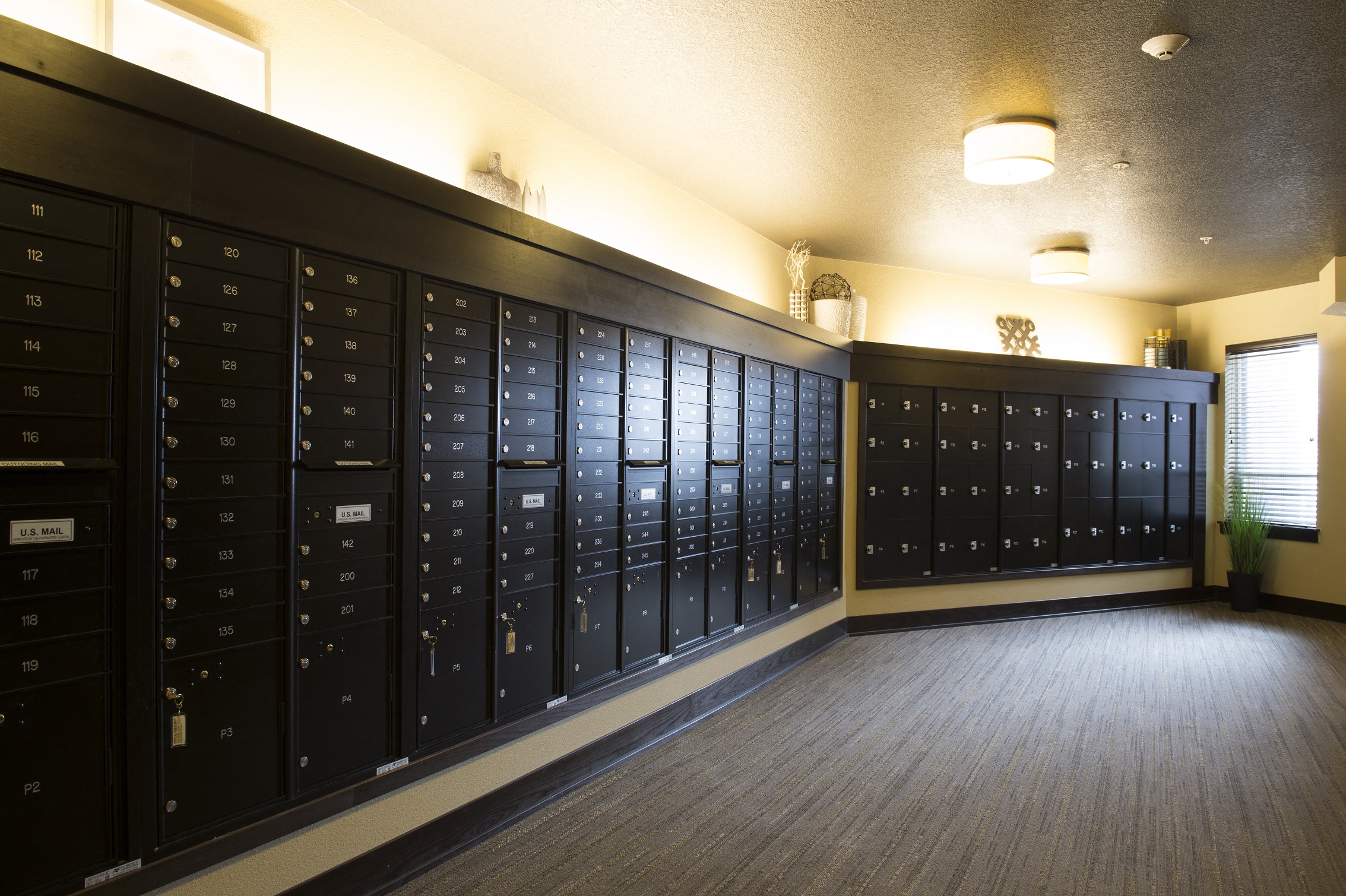 a row of mailboxes in a hallway at The Flats at Cedar Grove, Eagan, MN