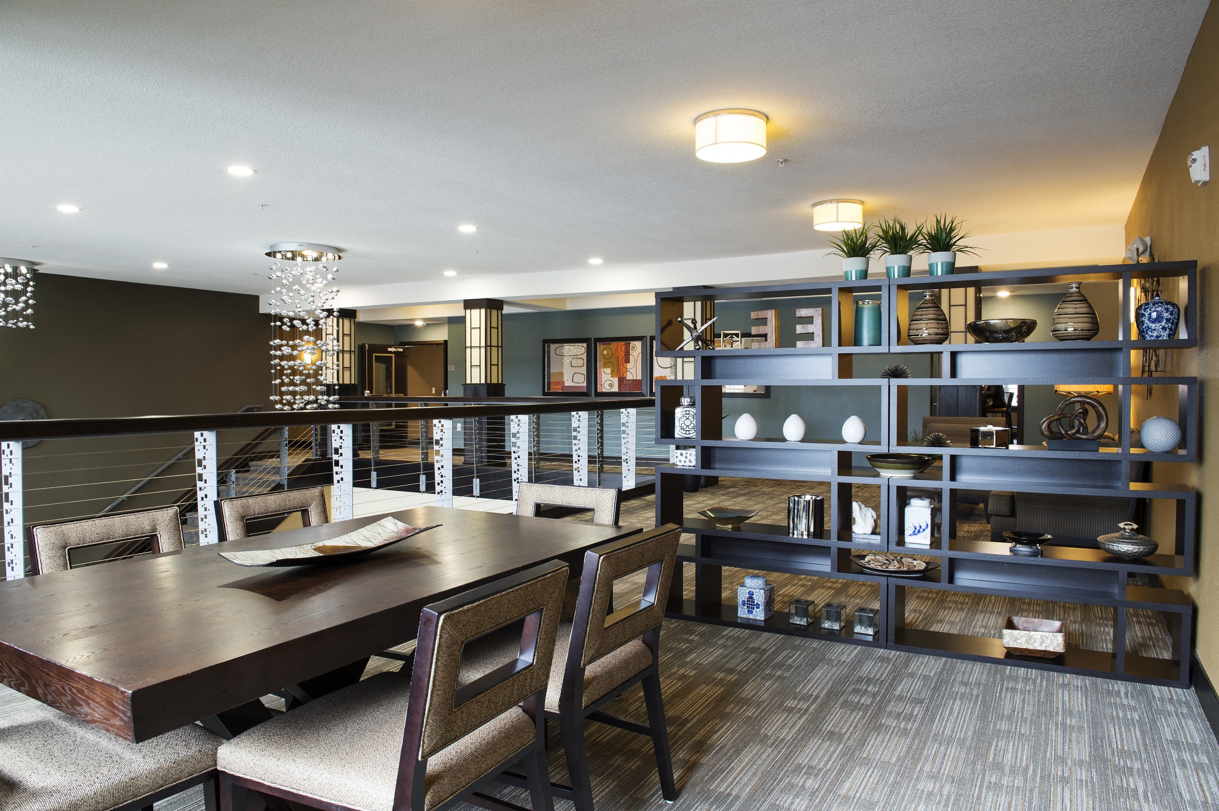 a common area with a table and chairs at The Flats at Cedar Grove, Minnesota