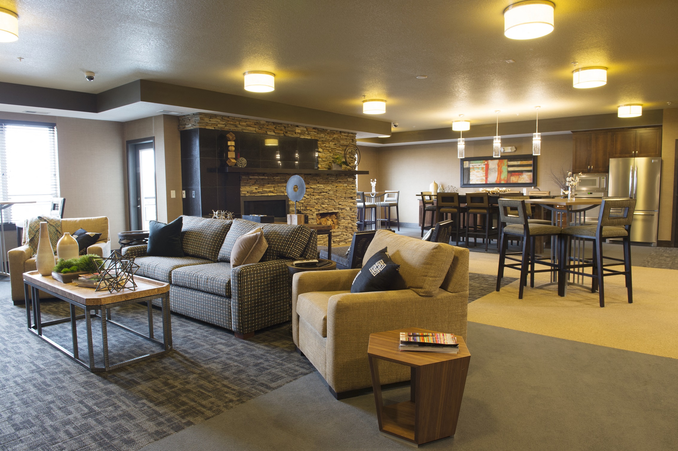 a community room filled with furniture and a fire place at The Flats at Cedar Grove, Eagan, MN, 55122