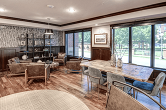 the retreat at thousand oaks clubhouse with wood flooring and large windows