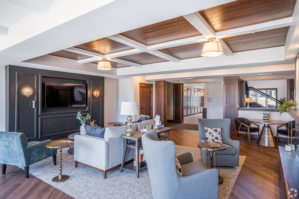 a living room with couches and chairs and a television