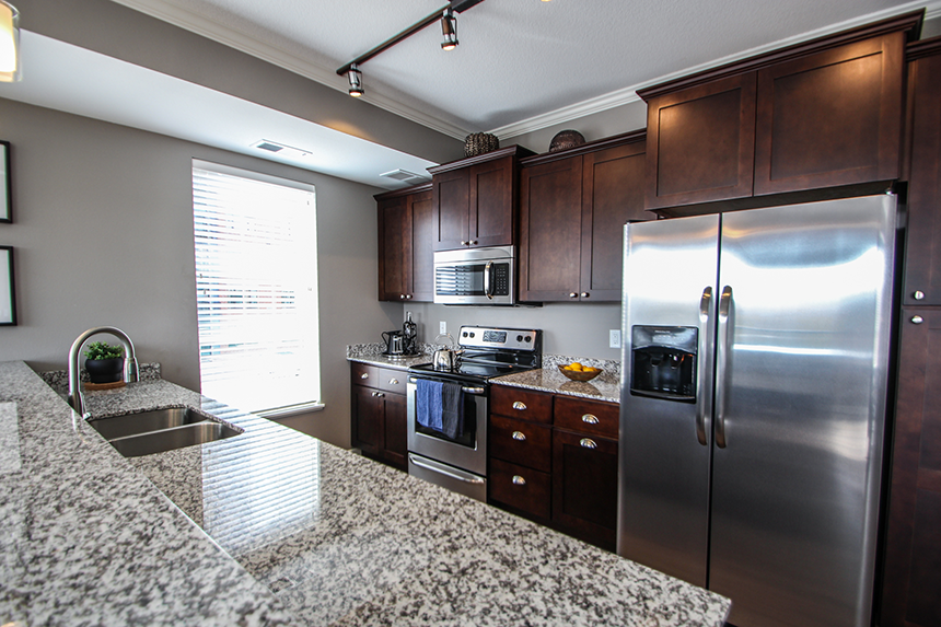 a kitchen with granite countertops and stainless steel appliances  at Victoria Park and V2 Apartments, St. Paul, MN, 55102