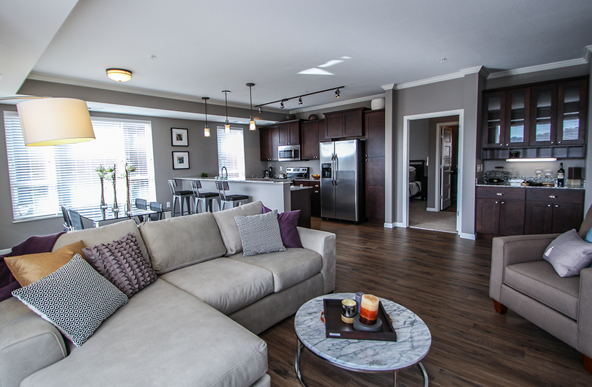 a living room with a couch and a table  at Victoria Park and V2 Apartments, Minnesota, 55102