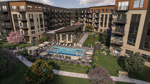 A large apartment complex with a pool and patio area.