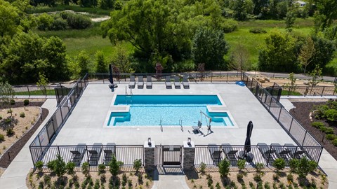 Aerial view of outdoor pool with dual hot tubs at The Carver Apartments, Minnesota